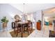 Dining room with table and chairs, chandelier, and sliding doors to the patio at 812 Adour Dr, Kissimmee, FL 34759