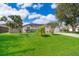 Charming single-story home with well-manicured lawn, mature trees, and lush landscaping at 812 Adour Dr, Kissimmee, FL 34759