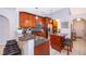 Modern kitchen with wooden cabinets, granite countertops, and stainless steel appliances at 812 Adour Dr, Kissimmee, FL 34759