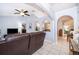 Bright living room with tile floors, ceiling fan, and arched doorways at 812 Adour Dr, Kissimmee, FL 34759