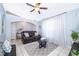 Bright living room with neutral paint, tile floors, an arched entry, and a modern ceiling fan at 812 Adour Dr, Kissimmee, FL 34759