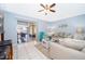 Bright living room with tile flooring, neutral walls, a sliding glass door, and access to the screened-in lanai at 812 Adour Dr, Kissimmee, FL 34759