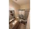 Bright bathroom featuring a granite-topped vanity and shower-tub combination at 939 Jaybee Ave, Davenport, FL 33897