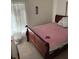 Bedroom with a wooden sleigh bed, light colored walls and window at 939 Jaybee Ave, Davenport, FL 33897