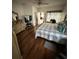 Serene bedroom with hardwood floors, a ceiling fan, and ample natural light at 939 Jaybee Ave, Davenport, FL 33897
