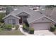 Aerial view of a single-Gathering home with a gray roof and attached garage at 939 Jaybee Ave, Davenport, FL 33897