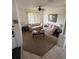 Inviting living room with plush sofas, a ceiling fan, and natural light from the window at 939 Jaybee Ave, Davenport, FL 33897