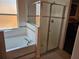 Bathroom showcasing a shower and tub with tile surround and glass door at 1006 Soaring Eagle Ln, Kissimmee, FL 34746