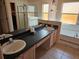 Bathroom featuring double sinks, bathtub, tiled floors, and a glass-enclosed shower at 1006 Soaring Eagle Ln, Kissimmee, FL 34746