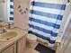 Bathroom featuring a vanity, toilet, and shower with striped curtain at 1006 Soaring Eagle Ln, Kissimmee, FL 34746