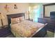 Cozy bedroom with wooden furnishings and a colorful patterned quilt on the bed at 1006 Soaring Eagle Ln, Kissimmee, FL 34746