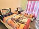 Charming bedroom with twin beds, decorative bedding, and a center nightstand at 1006 Soaring Eagle Ln, Kissimmee, FL 34746