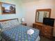 Bedroom with a bed and dresser with TV at 1006 Soaring Eagle Ln, Kissimmee, FL 34746