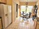 Cozy breakfast nook with a glass table, decorative chairs, and natural light streaming in through a large window at 1006 Soaring Eagle Ln, Kissimmee, FL 34746