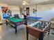 Spacious game room featuring a pool table, foosball table, and ping pong table at 1006 Soaring Eagle Ln, Kissimmee, FL 34746