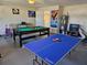 Entertaining game room featuring a pool table and ping pong setup for recreational fun at 1006 Soaring Eagle Ln, Kissimmee, FL 34746
