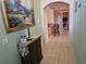 Hallway view into the living area with tiled floors and a decorative console table at 1006 Soaring Eagle Ln, Kissimmee, FL 34746