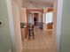 Open hallway leading to the living area with tiled floors and barstool seating visible at 1006 Soaring Eagle Ln, Kissimmee, FL 34746