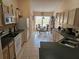 Well-lit kitchen with stainless steel appliances, neutral cabinets, and an adjacent dining area, perfect for preparing meals at 1006 Soaring Eagle Ln, Kissimmee, FL 34746