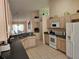 Kitchen features appliances, light wood cabinets, dark countertops and an open design at 1006 Soaring Eagle Ln, Kissimmee, FL 34746