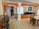 Open-concept living space with tile floors, arched doorways, comfortable seating, and a view of the dining area at 1006 Soaring Eagle Ln, Kissimmee, FL 34746