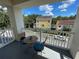 Charming balcony with comfortable seating and neighborhood views under a blue sky at 1020 Siena Park W Blvd # 304, Kissimmee, FL 34747