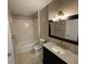 Bathroom with a shower-tub combo, decorative floors, granite countertop and updated vanity at 1020 Siena Park W Blvd # 304, Kissimmee, FL 34747