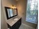 Bathroom featuring decorative floors, updated vanity with granite countertop, and a bright window at 1020 Siena Park W Blvd # 304, Kissimmee, FL 34747