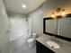 Bathroom with a shower-tub combo, decorative floors, granite countertop and updated vanity at 1020 Siena Park W Blvd # 304, Kissimmee, FL 34747
