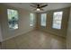 Inviting bedroom with tile flooring, ceiling fan, and three large windows for ample natural light at 1020 Siena Park W Blvd # 304, Kissimmee, FL 34747