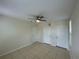 Neutral bedroom with tile floors and multiple white doors for closets and access at 1020 Siena Park W Blvd # 304, Kissimmee, FL 34747