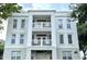 Stylish three-story condo building featuring white exterior and private balconies on the second and third floors at 1020 Siena Park W Blvd # 304, Kissimmee, FL 34747
