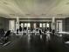 Well-equipped fitness center with weight machines and mirrored wall, providing a space for exercise at 1020 Siena Park W Blvd # 304, Kissimmee, FL 34747