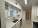 Well-lit kitchen with stainless steel appliances, light countertops and adjacent living spaces at 1020 Siena Park W Blvd # 304, Kissimmee, FL 34747