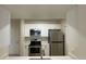 Contemporary kitchen with stainless steel appliances and white cabinetry at 1020 Siena Park W Blvd # 304, Kissimmee, FL 34747