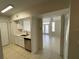 Open concept kitchen with white cabinets and stainless steel appliances that flows seamlessly into the living area at 1020 Siena Park W Blvd # 304, Kissimmee, FL 34747