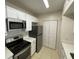 Bright kitchen featuring white cabinets, stainless steel appliances and a practical layout at 1020 Siena Park W Blvd # 304, Kissimmee, FL 34747