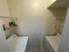 Functional laundry room with washer, dryer, and shelving at 1020 Siena Park W Blvd # 304, Kissimmee, FL 34747