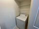 Practical laundry area including a white dryer and wire shelving for convenient storage at 1020 Siena Park W Blvd # 304, Kissimmee, FL 34747