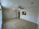 Spacious living room featuring tiled floors, neutral walls, and direct kitchen access at 1020 Siena Park W Blvd # 304, Kissimmee, FL 34747