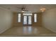 Bright living area boasts tiled floors, ceiling fan, and access to the patio through glass doors at 1020 Siena Park W Blvd # 304, Kissimmee, FL 34747