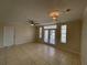 Cozy living space with tile flooring, ceiling fan, and glass doors leading to outdoor area at 1020 Siena Park W Blvd # 304, Kissimmee, FL 34747