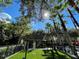 Swinging playground with turf, enhanced with tall palm trees, great community amenity at 1020 Siena Park W Blvd # 304, Kissimmee, FL 34747