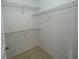 Walk-in closet with basic wire shelving and tile floors. Doorway visible at 1020 Siena Park W Blvd # 304, Kissimmee, FL 34747