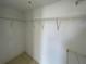 Walk-in closet featuring basic wire shelving and neutral colored tile floors at 1020 Siena Park W Blvd # 304, Kissimmee, FL 34747