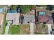 An aerial view shows the property's layout, including the house, driveway, and the surrounding landscaping and nearby swimming pools at 1022 Blue Horizon Dr, Deltona, FL 32725