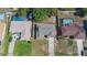 Aerial view of a single-story home with a grey roof, concrete driveway, and proximity to neighboring properties at 1022 Blue Horizon Dr, Deltona, FL 32725