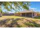 Spacious backyard featuring a screened in patio and a small shed at 1022 Blue Horizon Dr, Deltona, FL 32725