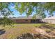 Large backyard with a covered patio and brick exterior at 1022 Blue Horizon Dr, Deltona, FL 32725