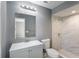 Modern bathroom featuring a marble-tiled shower and gray vanity at 1022 Blue Horizon Dr, Deltona, FL 32725
